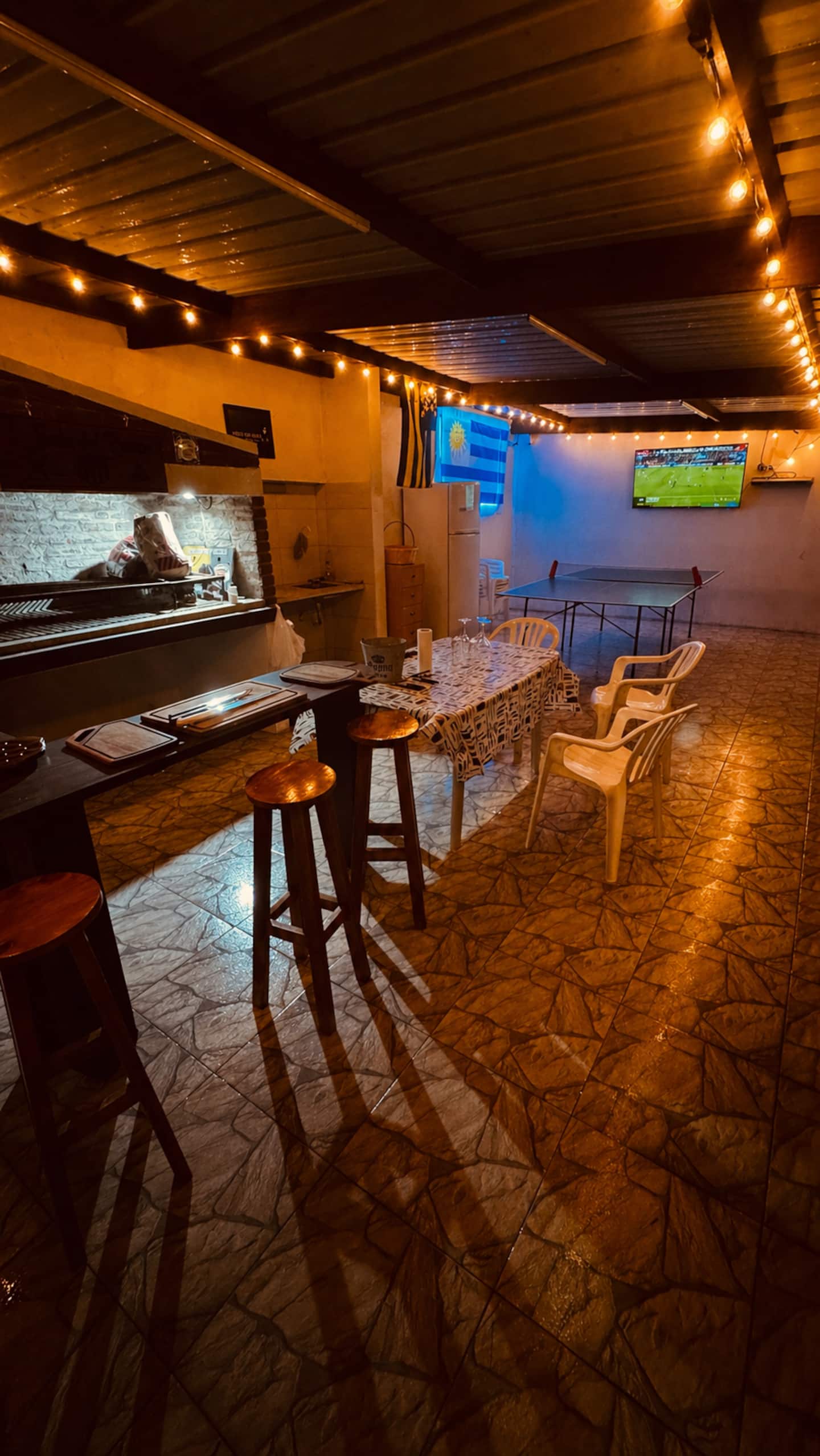 The welcoming barbecue space with warm string lights